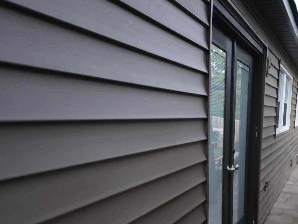 New CertainTeed Monogram siding along the patio side of a Joppa, MD home after siding replacement